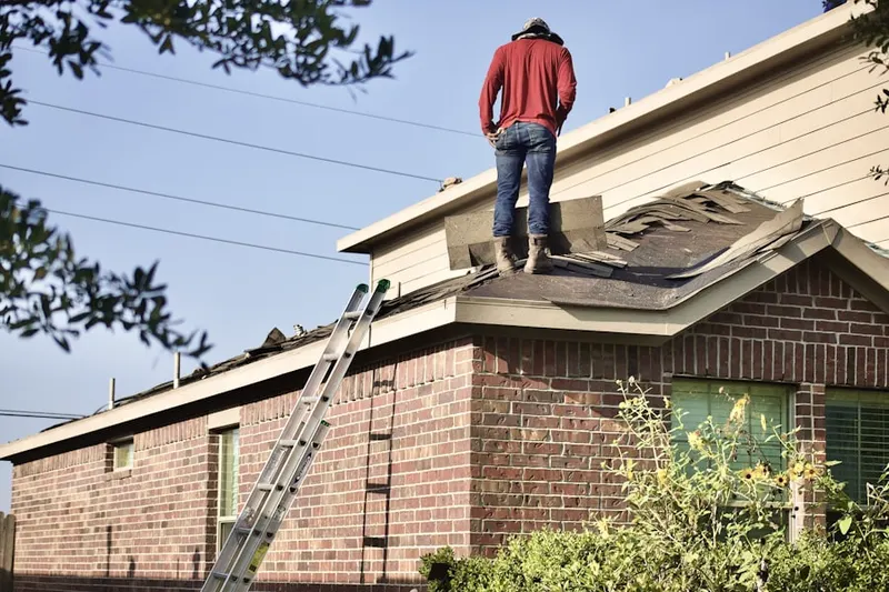 Professional roofer working on a residential roof in Admiralty Lakes Patio Homes